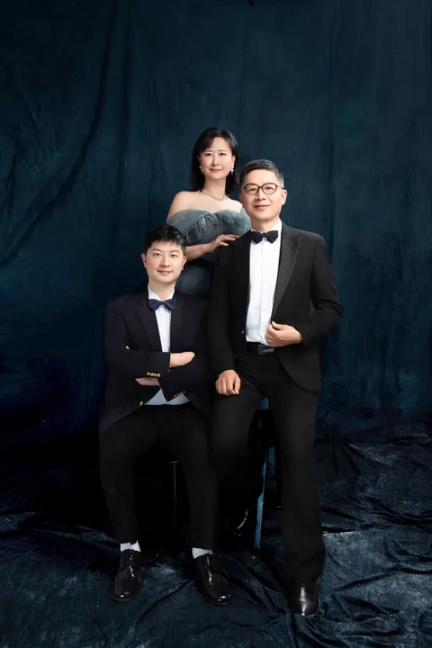 Three members of Jacky’s family in a formal studio portrait